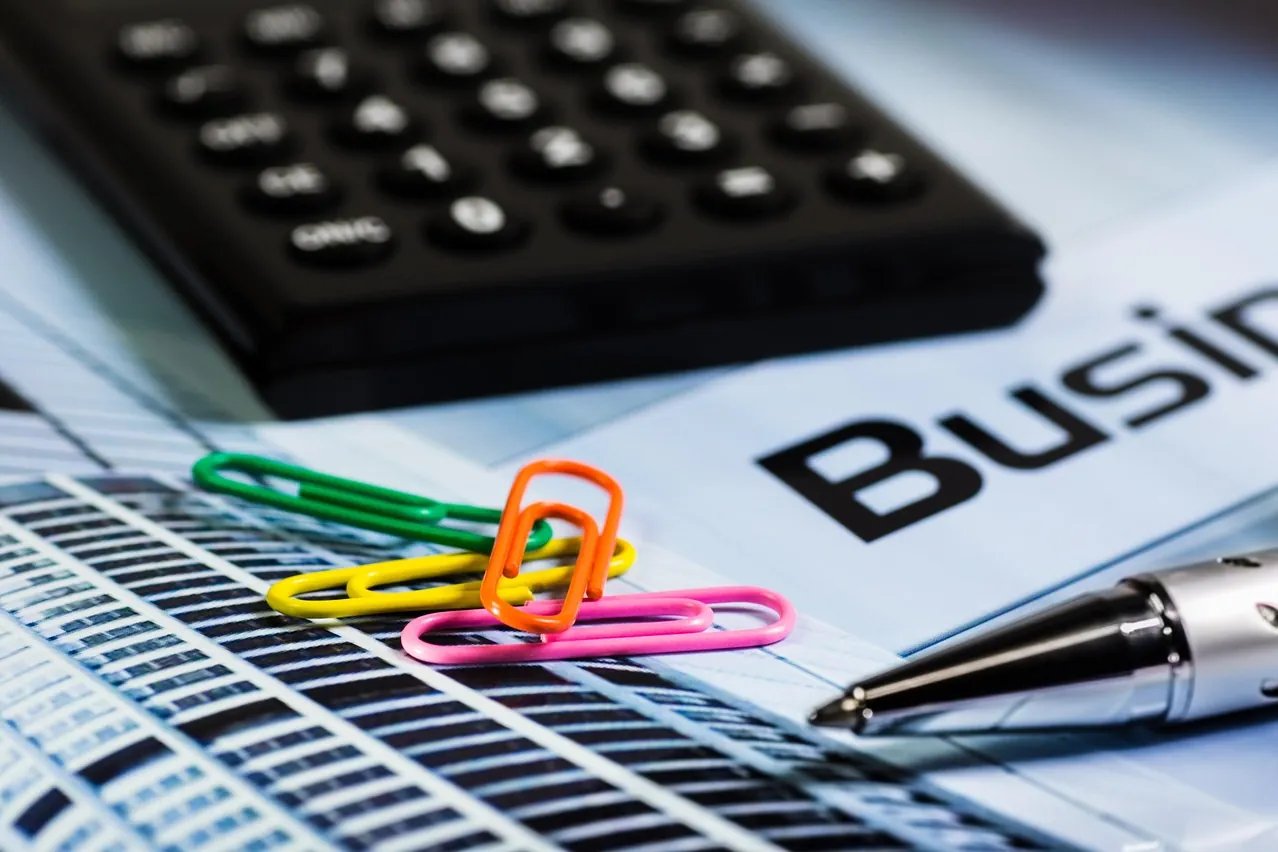 Calculator, paperclip, ballpoint pen